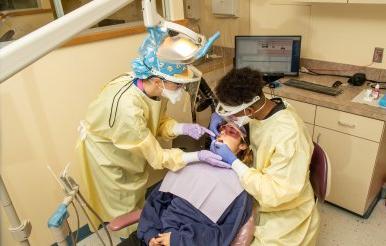 Dental hygiene student treats patient