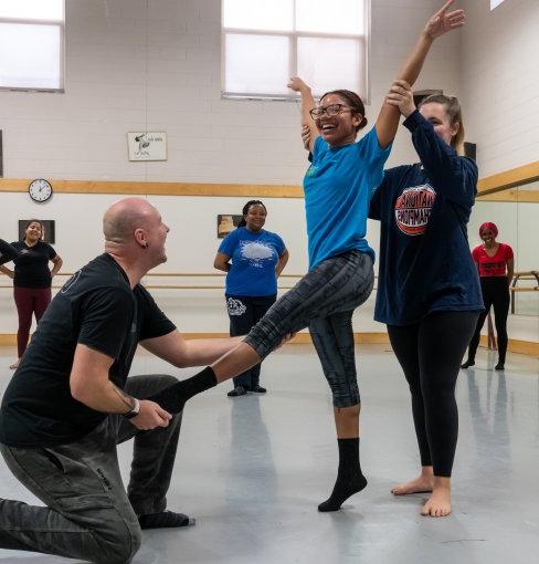 Instructor assists dance student at Pre-Collegiate Summer Dance Intensive.