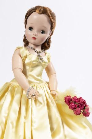 Photo of a doll in a yellow dress. 