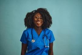 woman doctor smiling with stethoscope looking front